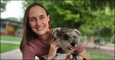Caitlin Fitz with her dog as faculty news feature