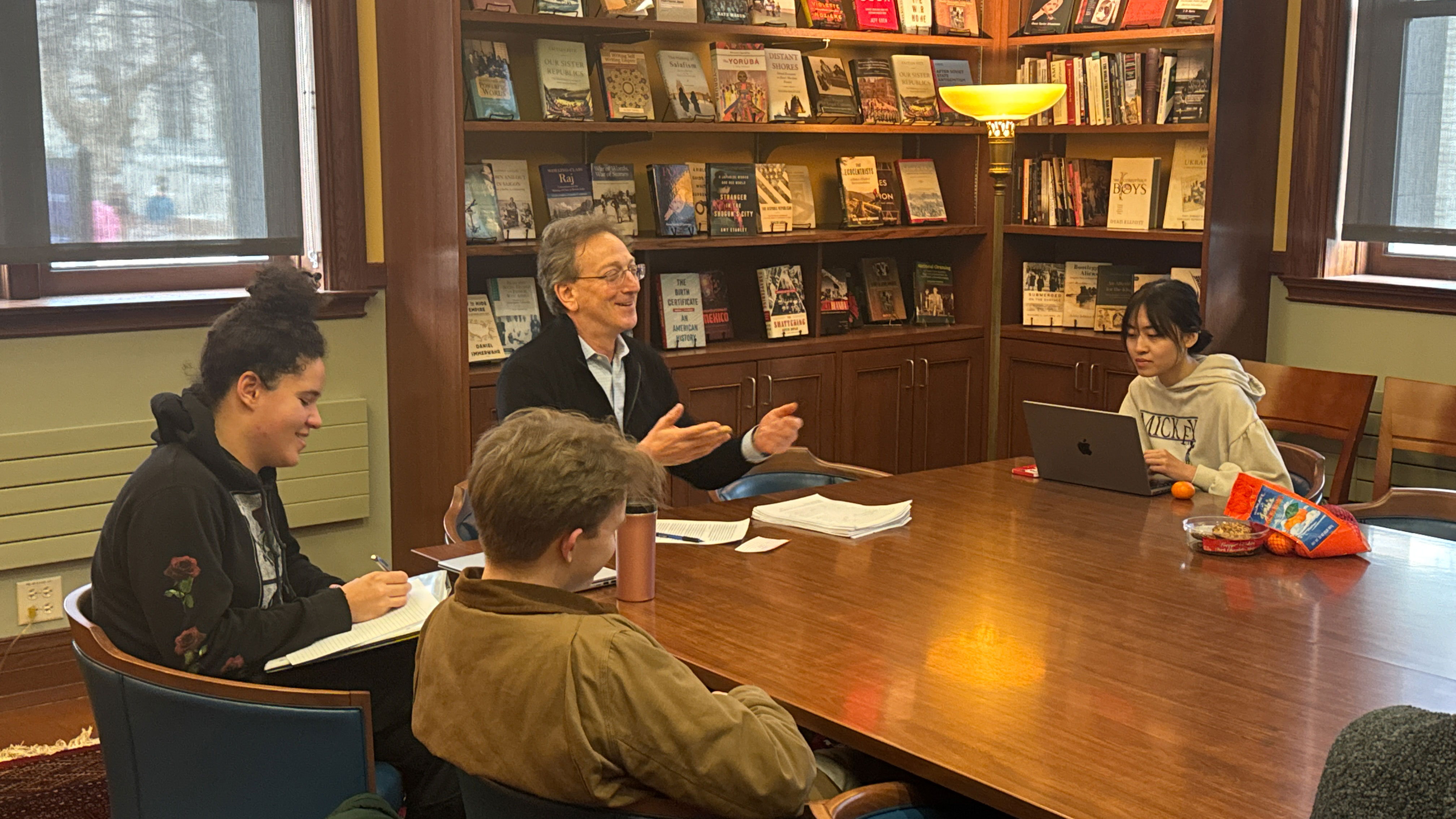senior thesis students discussing their writing around an open table