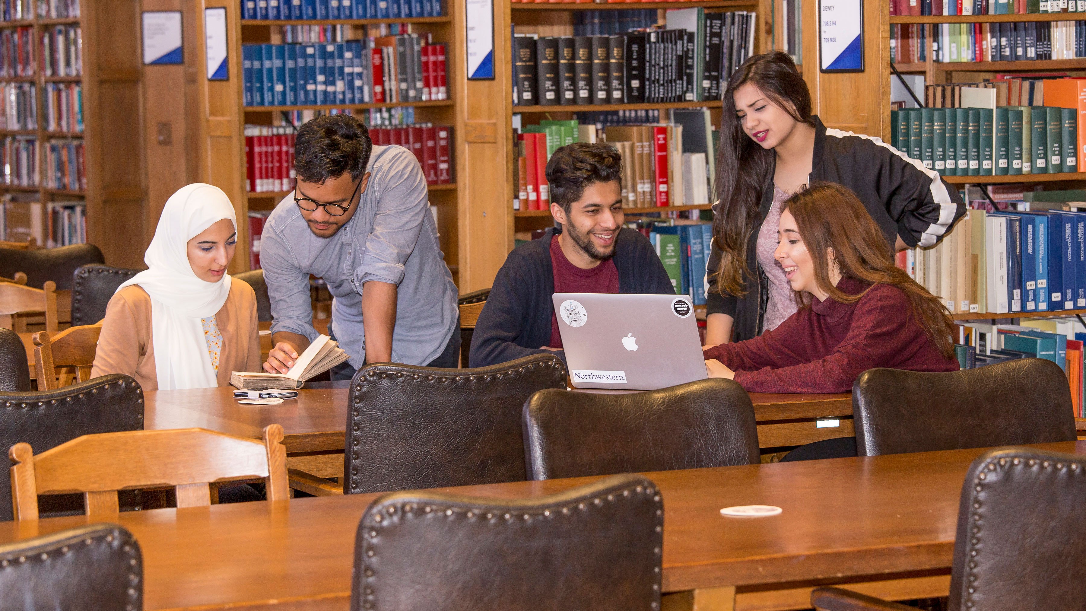 group of friends at the library studying together